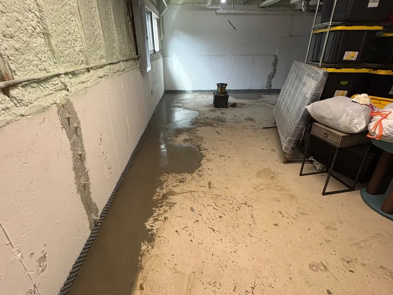 A block basement wall after an interior drain and wall liner were installed