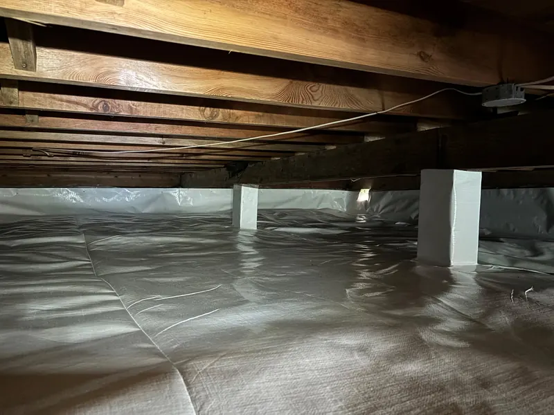 After: a crawl space with torn plastic on the dirt floor, then a sealed white liner