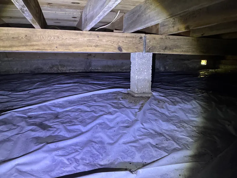 Before: a crawl space with torn plastic on the dirt floor, then a sealed white liner